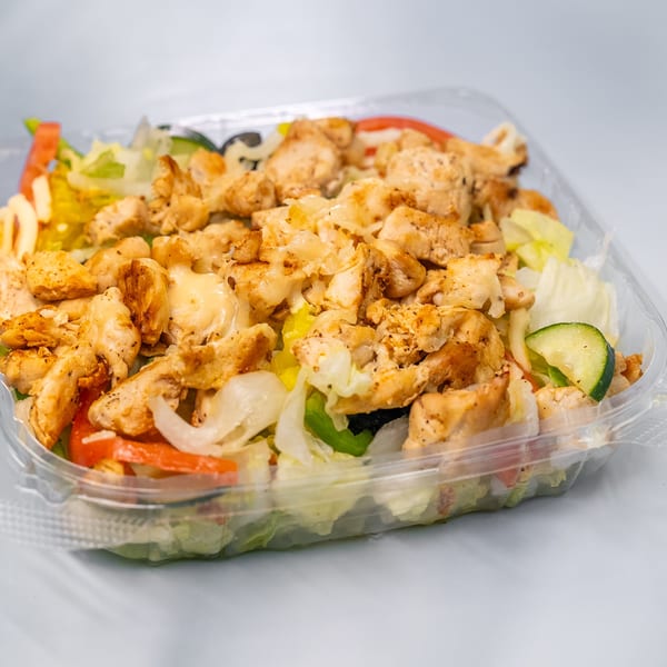 Sharks Fish & Chicken's grilled chicken salad with fresh vegetables in a clear plastic container.